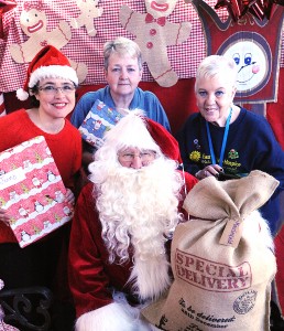 Grosvenor Centre manager Ed Kennedy with, from left, grotto organiser Sam Hatton, set designer Sue Pine and East Cheshire Hospice volunteer Midge Barber